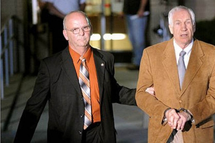 Jerry Sandusky is led in handcuffs by Centre County Sheriff Denny Nau after being found guilty June 22 on 45 counts of sexual abuse at the Centre County Courthouse in Bellefonte.
