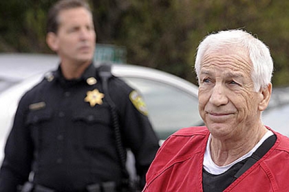 Former Penn State assistant football coach Jerry Sandusky in escorted into the Centre County Courthouse, for his sentencing on 45 counts of child sex abuse.
