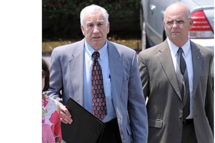 Jerry Sandusky leaves the Centre County Courthouse after the jury began deliberating his case. At right is Centre County Sheriff Denny Nau.