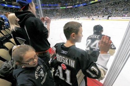 Pens fans line the glass watching practice before last week's scrimmage.