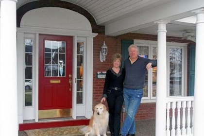 Jim and Mary Frances Miller on their front porch. Behind them is an original arched pediment found beneath the old portico during demolition.