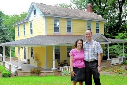 Daniel May and Jennifer Saitz pose for a portrait in front of their home in McCandless.