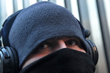 Joe Bogacki of the South Side waited along Stanwix Street in the cold yesterday for a bus. Slightly colder temperatures today will mean more bundling up for commuters.