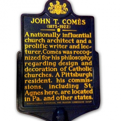 The historical marker for "nationally influential church architect" John T. Com&egrave;s.