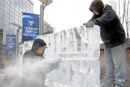 Richard Bubin and his nephew, Jeff Bubin, of Ice Creations assemble a "Great Day for Hockey" ice sculpture outside the Consol Energy Center Wednesday.