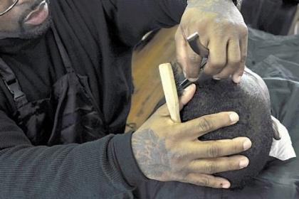 Paul Perminter, left, who had been studyng at the school for four months, does a trim.