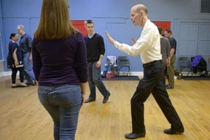Instructor Jerry Minshall demonstrates dance moves to Holly Forsberg and Conor Shaffer, both of Squirrel Hill.