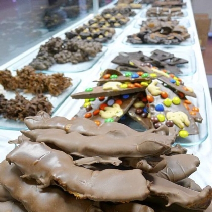 Chocolate-covered bacon, foreground, is one of the many hand-dipped candy specialties at the new Sinful Sweets at 901 Penn Ave., Downtown.