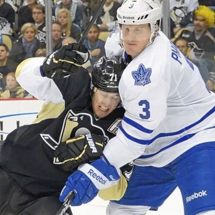 Evgeni Malkin is taken down in front of the net by Toronto's Dion Phaneuf in the third period Wednesday night at Consol Energy Center. Malkin scored his first goal of the season, but it wasn't enough as the Maple Leafs spoiled the Penguins home opener.