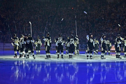 Penguins wave to the crowd at opening night ceremonies at Consol Energy Center on Wednesday night.