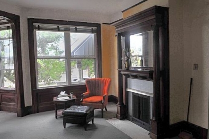 The front room of the Wigman house in a photograph taken last summer, showing an original fireplace and mantel.