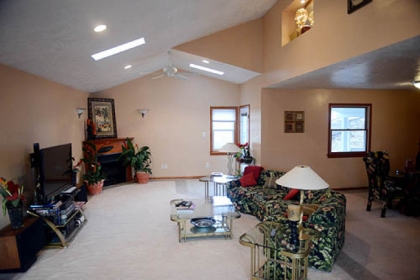 The living room with its slanted ceiling and three skylights is flooded with sunlight on most days.