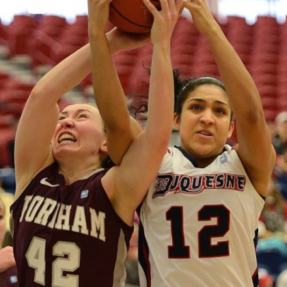 Duquesne's Jocelyn Floyd fights for the rebound against Fordham's Abigail Corning.