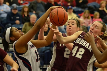 Duquesne's Wumi Agunbiade fights for a rebound against Fordham's Abigail Corning.