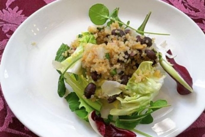 Quinoa and black bean salad with pumpkin seeds and lime.