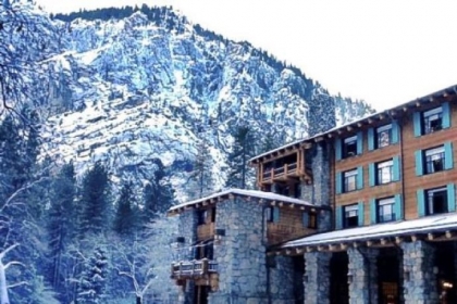 The Ahwahnee Hotel is set against the granite mountains of Yosemite National Park in winter.