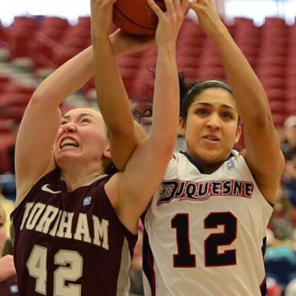 Duquesne's Jocelyn Floyd, right, fights with Fordham's Abigail Corning for a rebound.