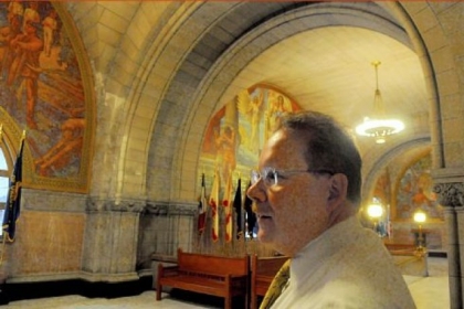 Allegheny County manager William McKain talks about some of the maintenance issues at the courthouse, including marks on the wall at left, caused by water leaks.