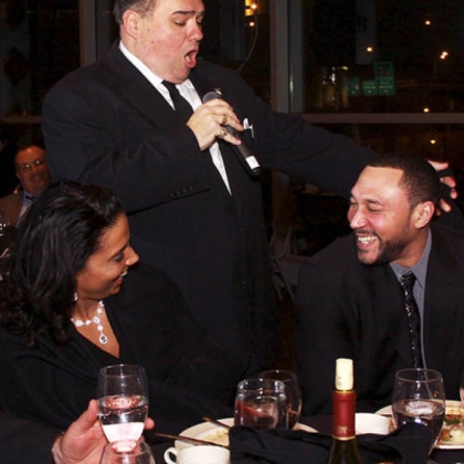 Latasha Batch looks on as Dominic Mantuso of The Three Waiters serenades Charlie Batch.