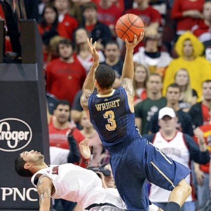Louisville's Peyton Siva takes a charge from Pitt's Cameron Wright during the second half.