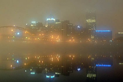 Pittsburgh's foggy skyline is reflected in the rivers before sunrise today.