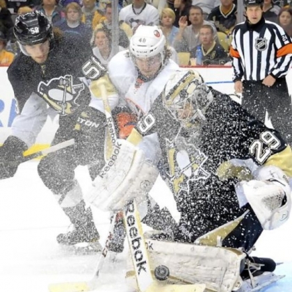 Goalie Marc-Andre Fleury somehow finds the puck through the ice storm kicked up by the Islanders' Michael Grabner in the second period Tuesday at Consol Energy Center.