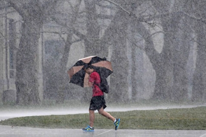 A student crossing The Cut at Carnegie Mellon University got caught in this morning's rain.