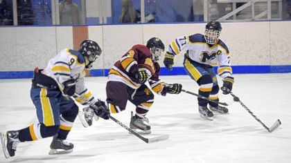 Roman Kraemer (3) of Serra Catholic controls the puck against Mars' Ed Schwadron, left, and Reed Salada in the Planets' 2-1 victory Nov. 21. After starting the year 1-3, Serra Catholic won its next five games.