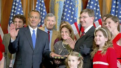 House Speaker John Boehner, R-Ohio, left, performs a mock swearing in for Rep. Keith Rothfus, R-Pa., and his family Thursday on Capitol Hill in Washington as the 113th Congress convened.