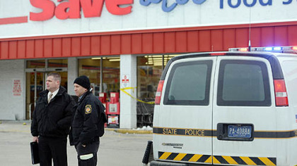 Pennsylvania State Police outside a Save-A-Lot store at Crossroads Plaza in East Huntingdon where a trooper shot and killed a man authorities said stabbed the trooper.