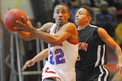 Wilkinsburg's Isaiah Pete gets around Clairton's Bryon Clifford on his way to the basket during a non-section game last Saturday.
