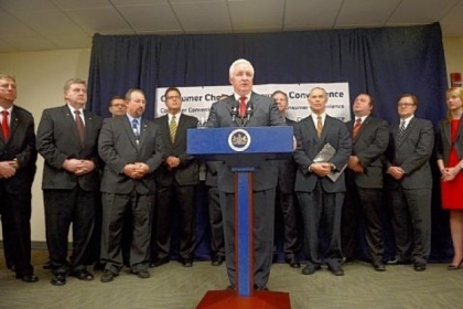 Gov. Tom Corbett, backed by legislators, public officials and supporters during a news conference Wednesday in Downtown, details his plan to sell the state liquor store system. House Majority Leader Mike Turzai, R-Bradford Woods, is fourth from right.