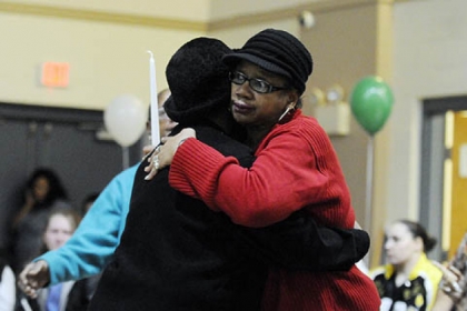 Lachoa Austin, left, of McKees Rocks comforts Carrol Dent of Youngstown, Ohio, the sister of Isaiah Dent, 61, during a memorial service.