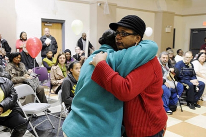 Laverne Jackson, left, of Wilmerding, and Carrol Dent of Youngstown, Ohio, sisters of  AIsaiah Dent, 61, comfort each other at a memorial service.