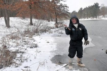 Jerry Roman stands at the edge of snow- and iced-covered North Park Lake to cast his line into the unfrozen portion of the lake last week.