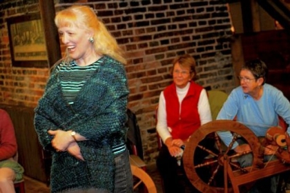 Diane Bartels from Greensburg models a shawl she made during the Spinners Guild meeting. Norma Brodak and Sandy Truckner sit in the background.