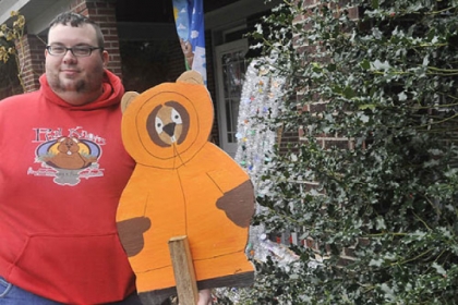 Anthony Skariot, co-founder of the The Outer Circle, a club that celebrates Groundhog Day all year round, with a groundhog cutout painted to look like the character Kenny from the television show South Park. The cutout is a small part of a collection of groundhog-related items at his Castle Shannon home.