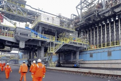 Officials walk the length of the new battery coke ovens Thursday, following a ceremony at U.S. Steel's Clairton Plant. The company has invested over $500 million to build the new battery and make other improvements.