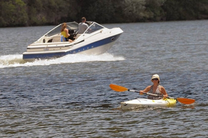A speedboat passes a kayak on the Monongahela River last June near South Side Riverfront Park. The Mon this morning was named Pennsylvania's 2013 River of the Year following public online voting across the state.