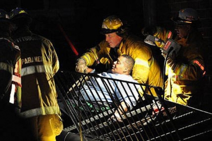 Pittsburgh rescue workers free Annette Wade, 52, from a collapsed stairway Thursday at the Allegheny Commons East complex on the North Side.