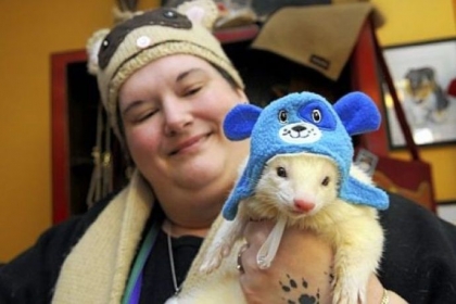 Shannon Moore of Oakland holds her ferret, Mr. Vanilla Bean, during the Winter Wonderland party.