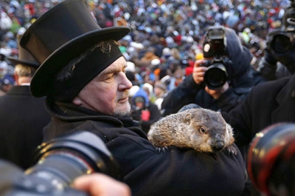 Groundhog Club Co-handler John Griffiths holds the weather predicting groundhog, Punxsutawney Phil, as he is surrounded by photographers at Groundhog Day festivities in Punxsutawney this morning.