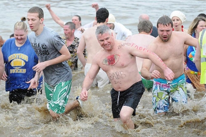 Ed Shea of Thornburg heads back out of the Monongahela River with other members of the Pitts-burrrrrgh Drowned Hogs at Southside Riverfront Park, after plunging into the river today to raise money for Circle C Youth and Family Services, of which Mr. Shea is a board member.