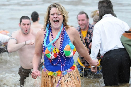 Stacy Moffatt of Scott heads back out of the Monongahela River with other members of the Pitts-burrrrrgh Drowned Hogs at Southside Riverfront Park, after plunging into the river today to raise money for Circle C Youth and Family Services.