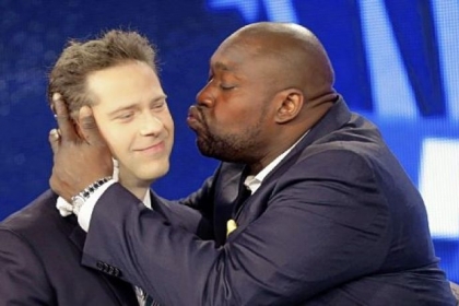 A jubilant Warren Sapp, right, kisses Chris Rose, who served as host of the Pro Football Hall of Fame announcement show Saturday for NFL Network.