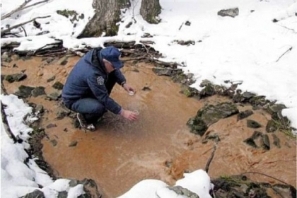 A Fish and Boat Commission researcher takes a water sample during a permit application review.