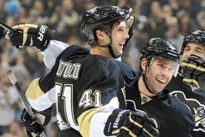Robert Bortuzzo, left, is mobbed by teammates after scoring his first NHL goal in the Penguins' 5-1 rout of New Jersey Saturday at Consol Energy Center.