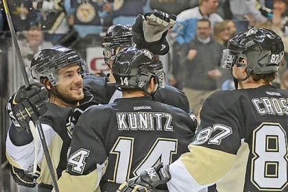 Penguins defenseman Kris Kunitz is mobbed by teammates after scoring in the third period against the New Jersey Devils on Feb. 2 at the Consol Energy Center.