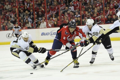 Washington Capitals left wing Alex Ovechkin (8) chases after the puck against Penguins right wing Craig Adams (27) and Kris Letang (58) during the first period.