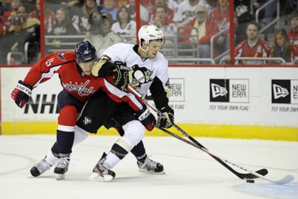 Washington Capitals right wing Joey Crabb battles for the puck against Penguins defenseman Simon Despres during the first period.